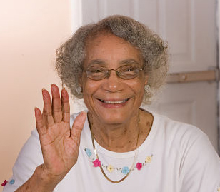 elderly woman waving and smiling